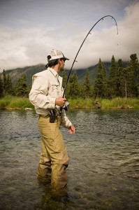 manFishingStandingInWater